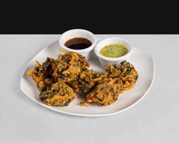 Assorted vegetable pakoras on a tray